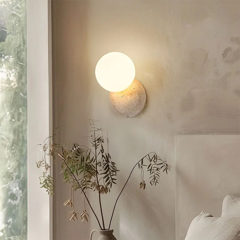 travertine stone outdoor wall sconce, installed in a room interior setting