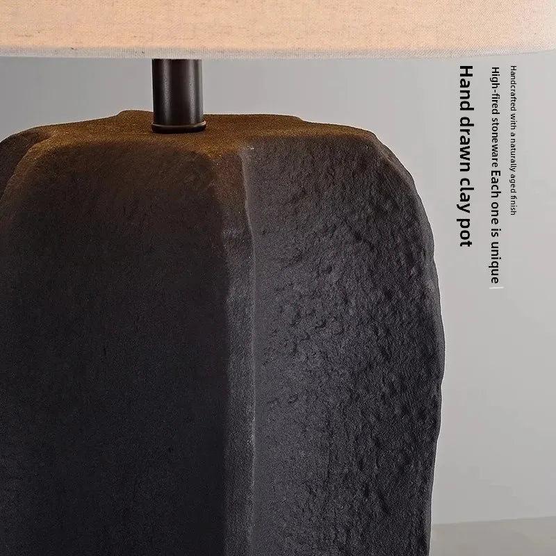 White handmade pottery lamp illuminated in warm ambient setting