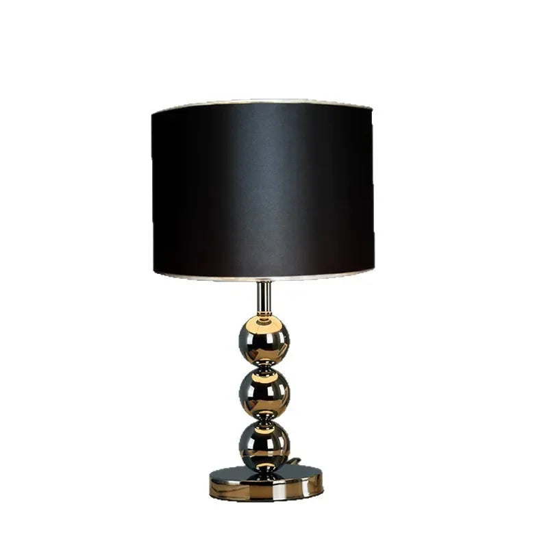 Gold desk lamp illuminated showing warm amber light output