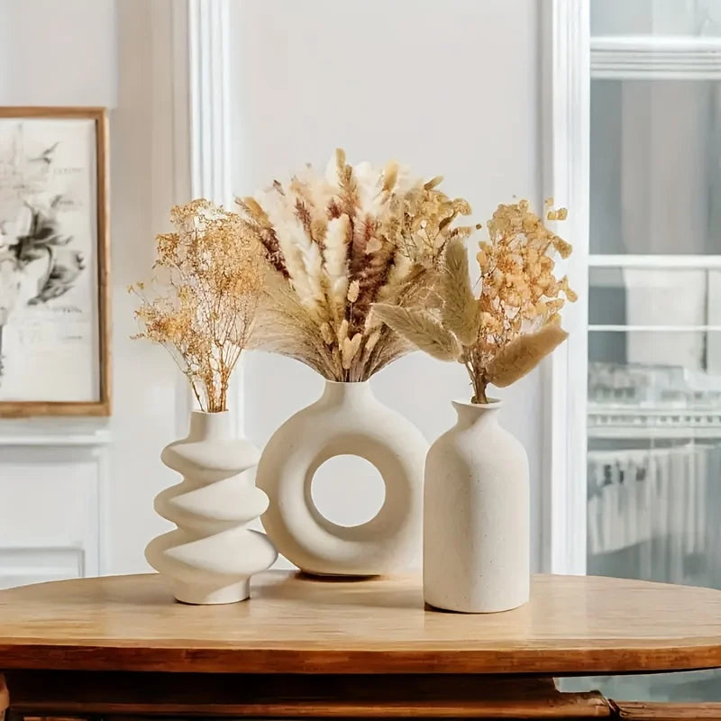 Three-piece boho ceramic vase set in varying heights on wooden shelf