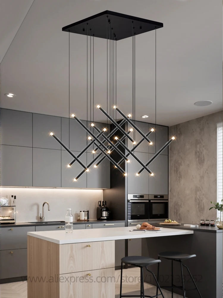 Long chandelier lit in warm light down a villa stairwell
