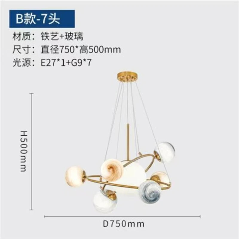 Globe chandelier lit in white light with gold plated metal arms