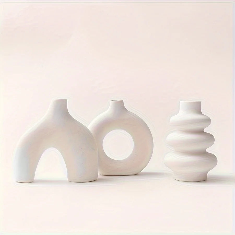 Light yellow ceramic vase from boho set with dried cotton stems on wooden shelf
