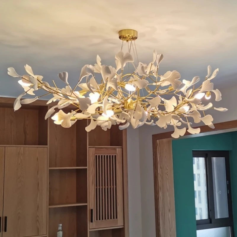 Ceramic ginkgo leaf detail on the brushed iron chandelier arm