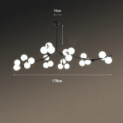 Glass branch chandelier shown lit in warm white G9 LED light