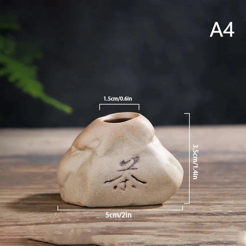 Stone-texture ceramic bud vase A7 in earthy brown tone on concrete desk surface