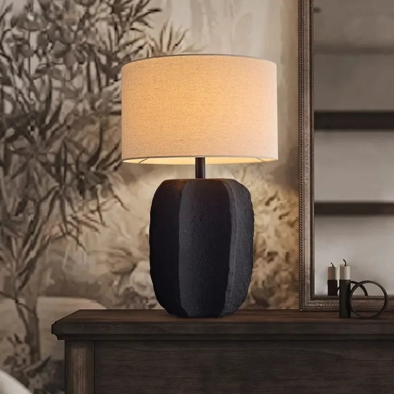 White clay pottery lamp casting warm light in Japanese retro bedroom