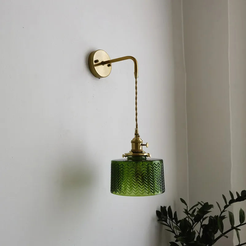 green copper wall sconce, installed in a room interior setting