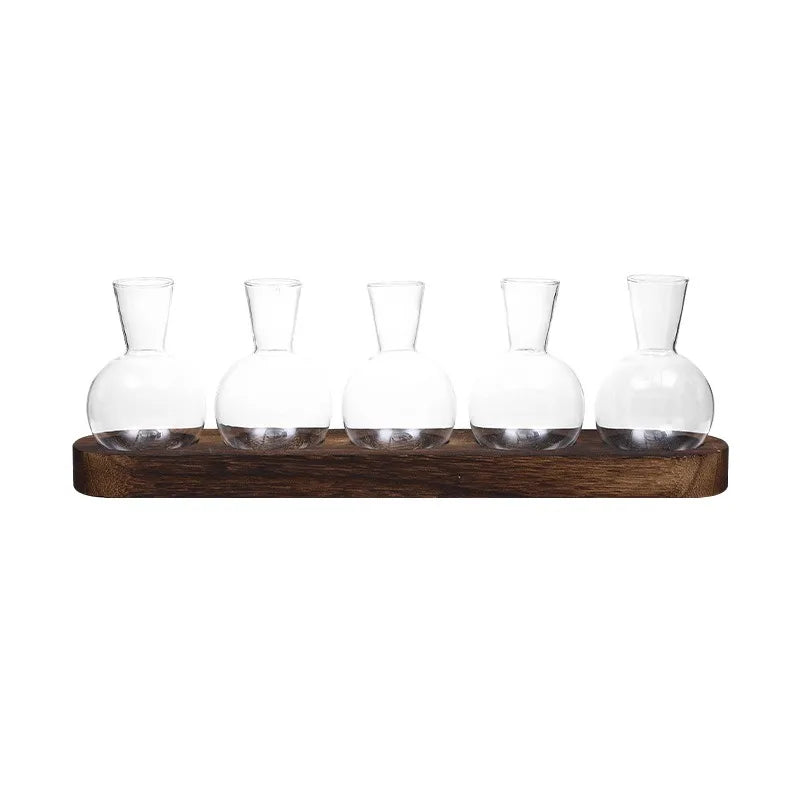 Glass terrarium on wooden tray styled on contemporary home office desktop