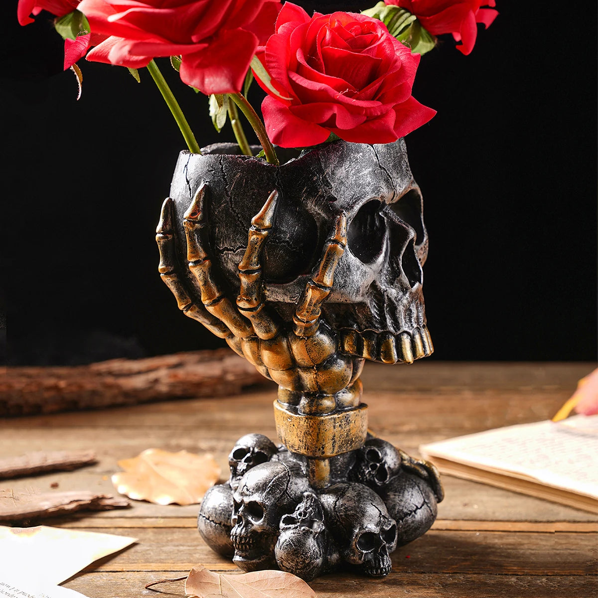 Silver-black steampunk skull resin vase with mechanical detail on dark shelf