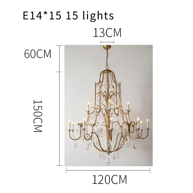 Crystal drop detail on an antique gold candle arm chandelier