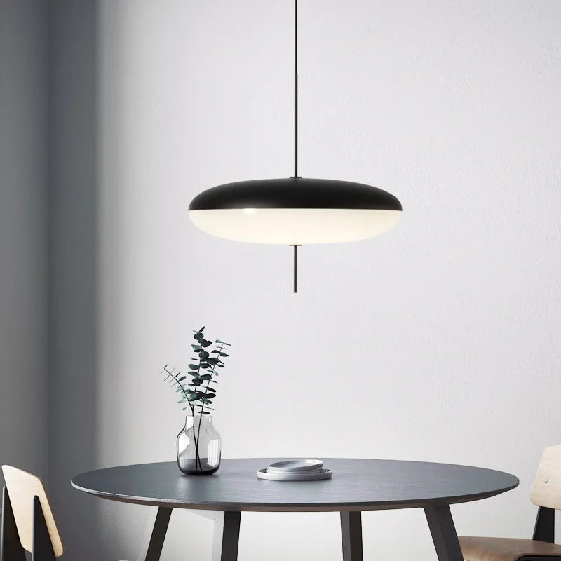 Acrylic shade chandelier diffusing warm 3000K light into a soft glow