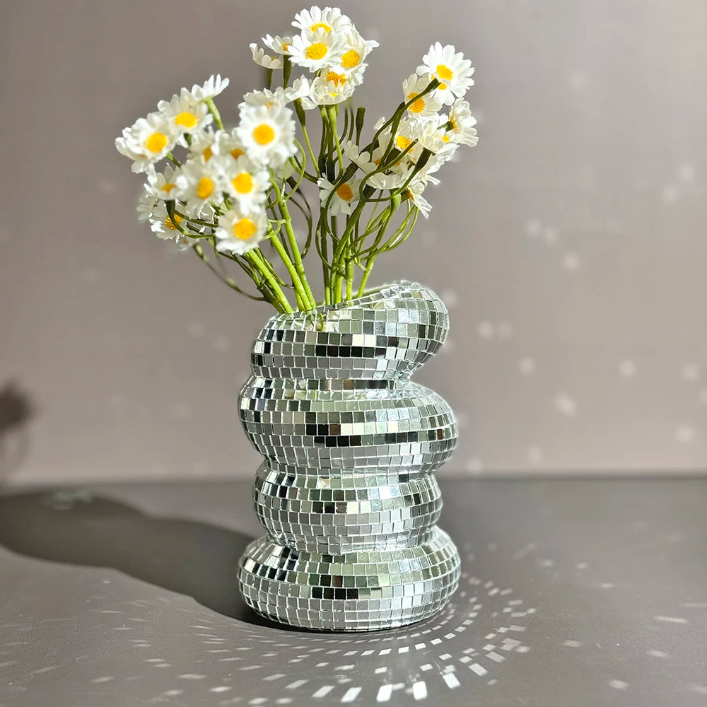 Silver mirror mosaic disco ball glass vase on a marble console table