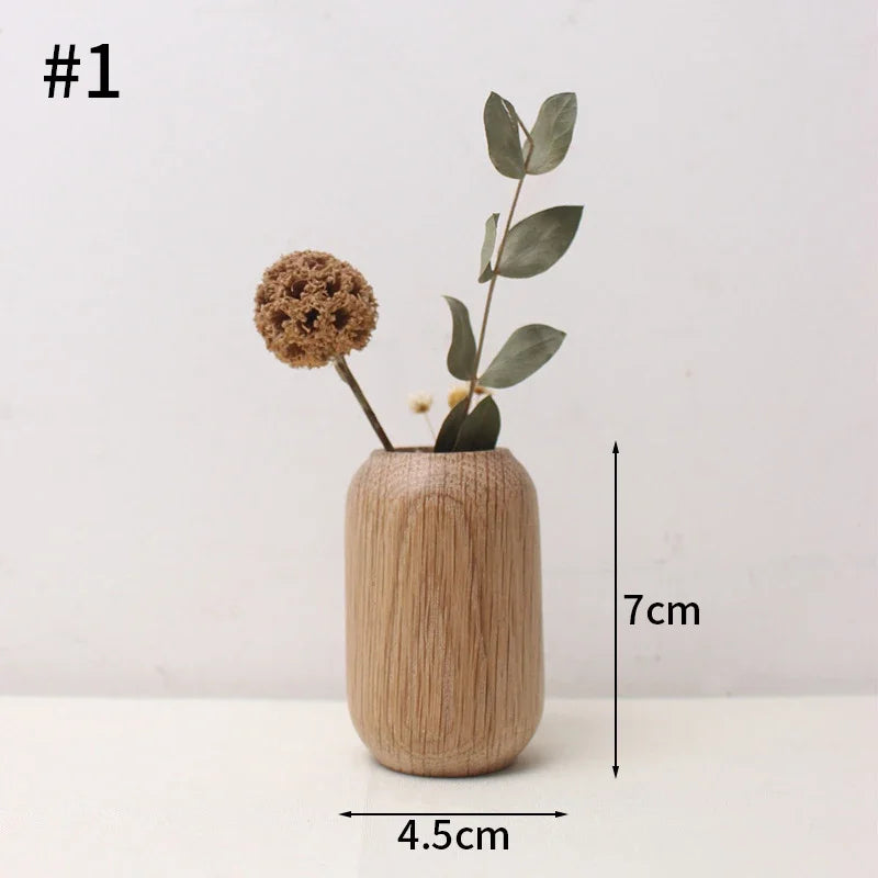 Overhead view of Japanese wooden flower desk vase with fresh slim branch inside