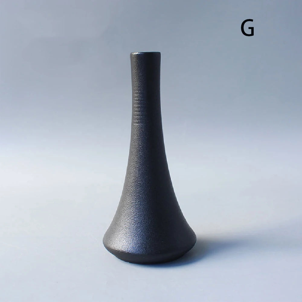 Japanese ceramic small vase with single dried eucalyptus branch inside