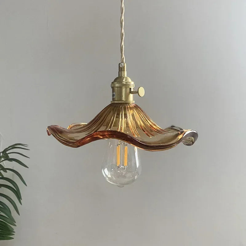 Green glass chandelier shade paired with a polished copper cord pendant fitting