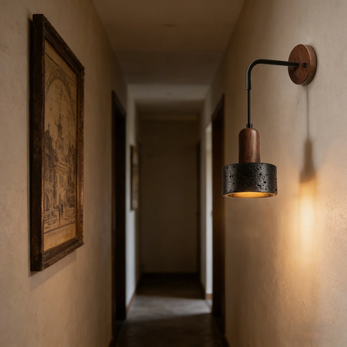 black travertine stone wall sconce, detail view of fixture base and arm