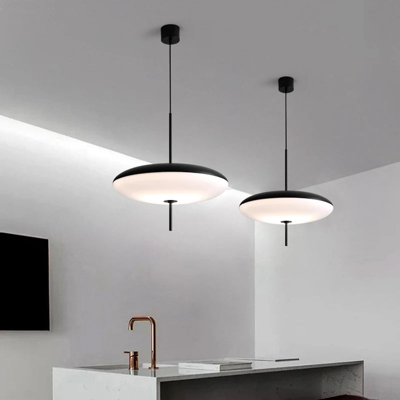 Contemporary acrylic chandelier with three shades on a plated iron body