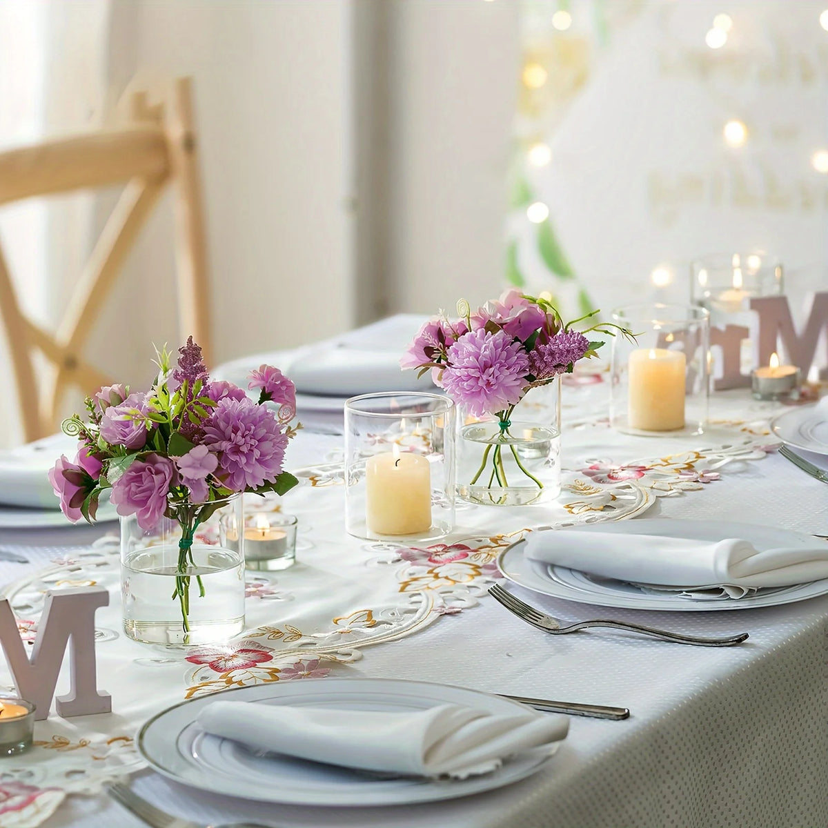 Clear acrylic cylinder vase set arranged on white linen dining table for styling