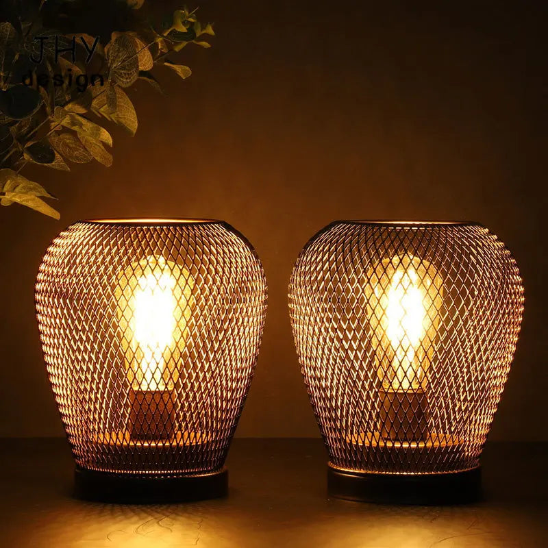 Metal cage egg lantern cordless table lamp switched on warm white glow