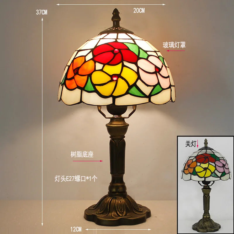 W type Tiffany stained glass bedside lamp switched on warm glow
