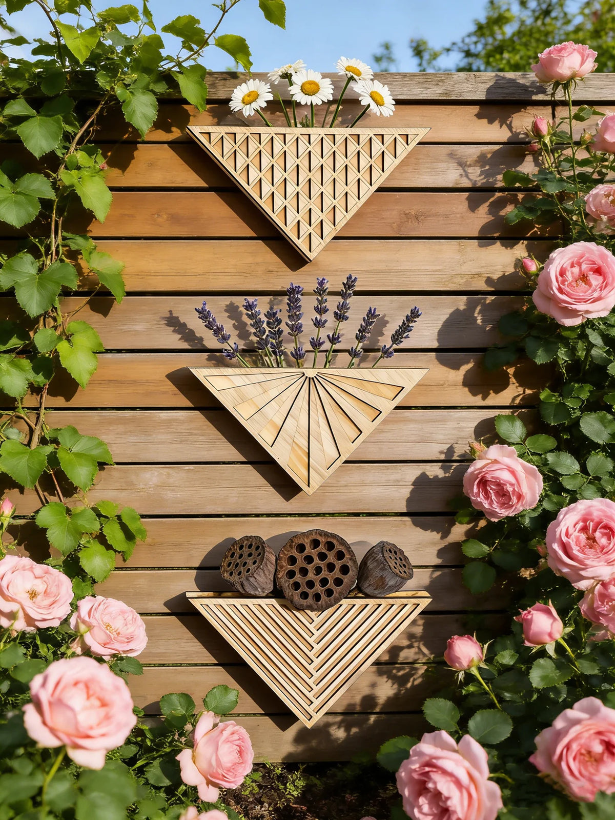 Large geometric triangle wall planter with trailing plant on balcony wall