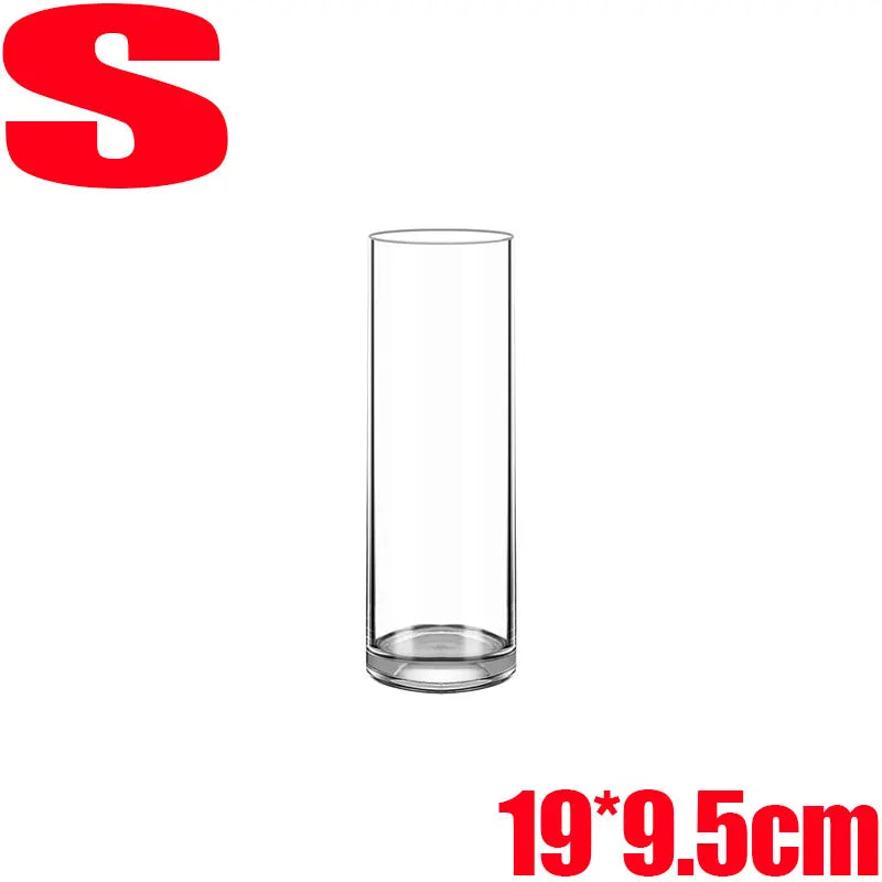 Clear acrylic cylinder vase styled in minimalist office