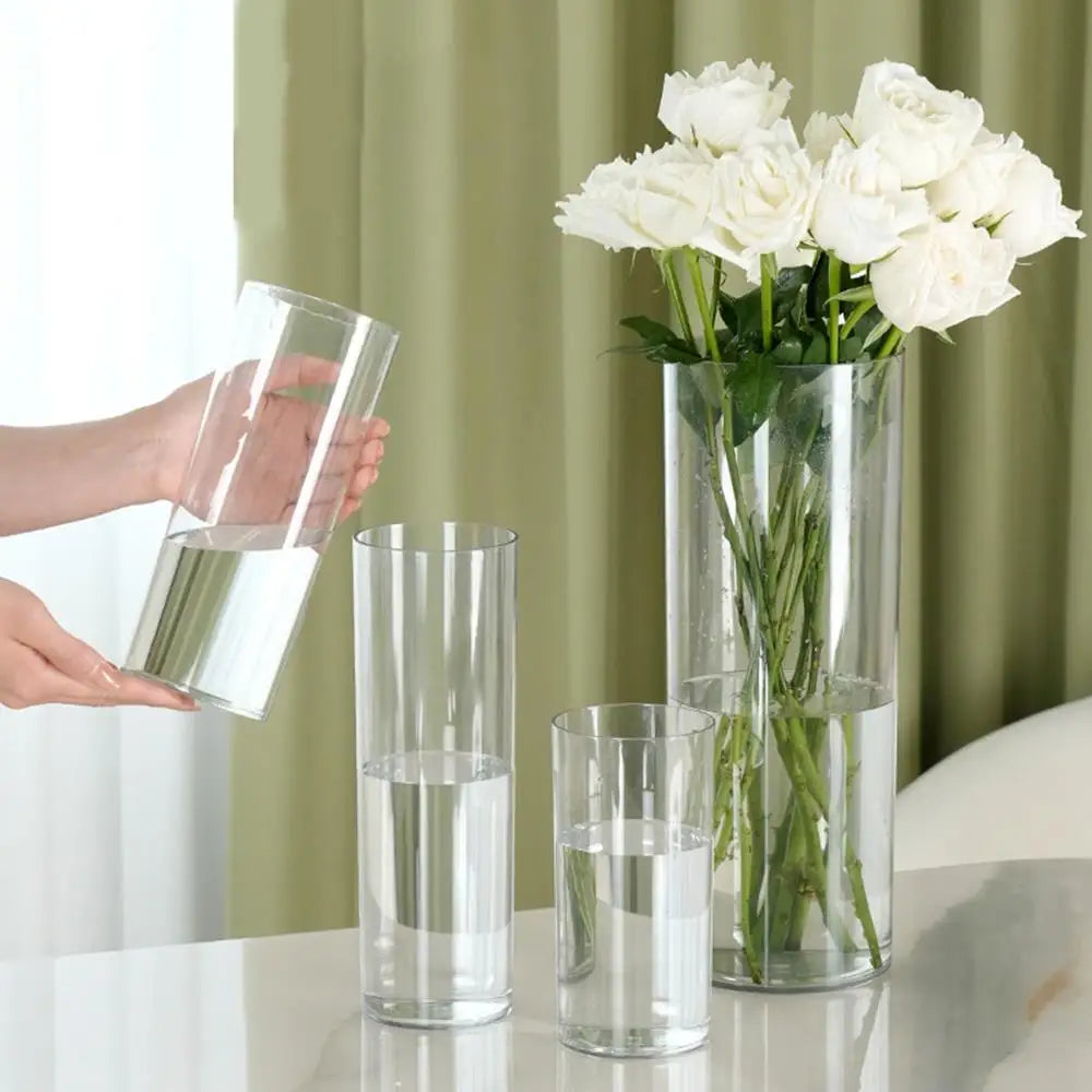 10x25cm clear plastic vase with white lily bouquet photographed from above