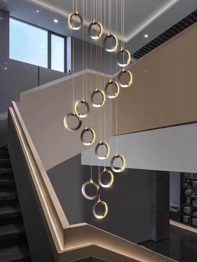 Cascading ring chandelier in all black, eight rings over a stairwell void