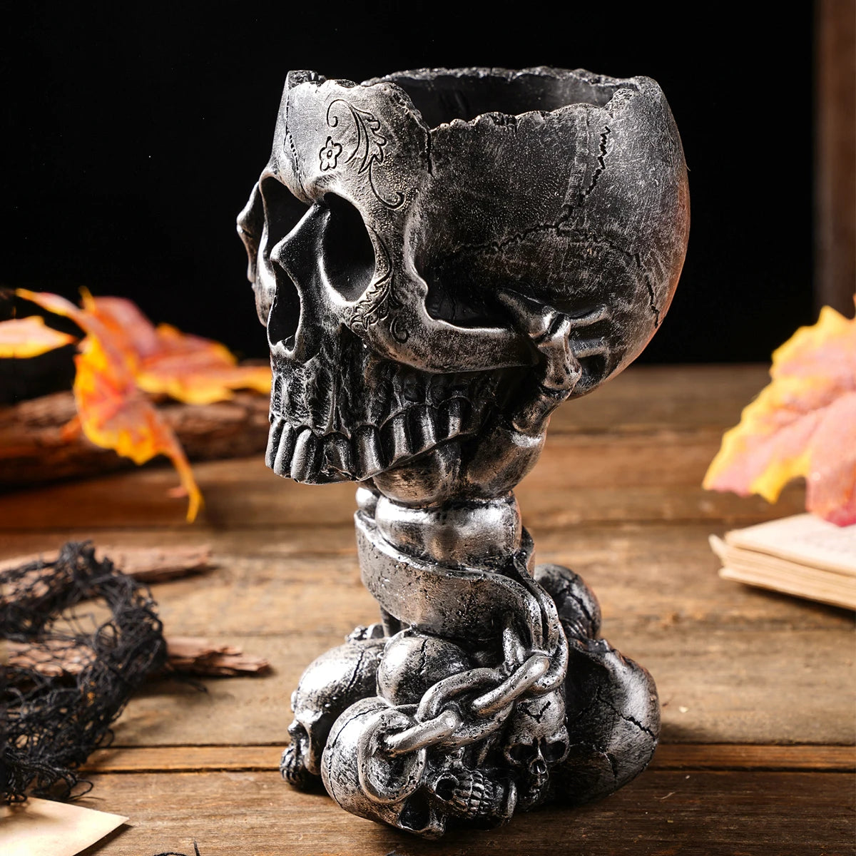White steampunk skull resin novelty vase with dried black flowers placed inside