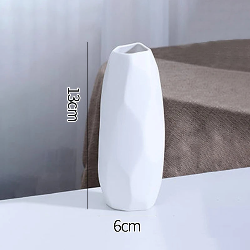 White ceramic vase C10 in soft morning light on kitchen windowsill beside greenery