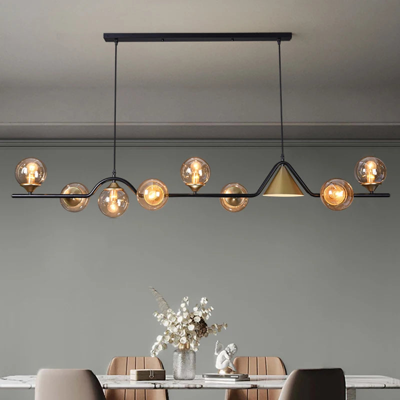 Linear chandelier with tinted glass shades spaced along a slim alloy bar