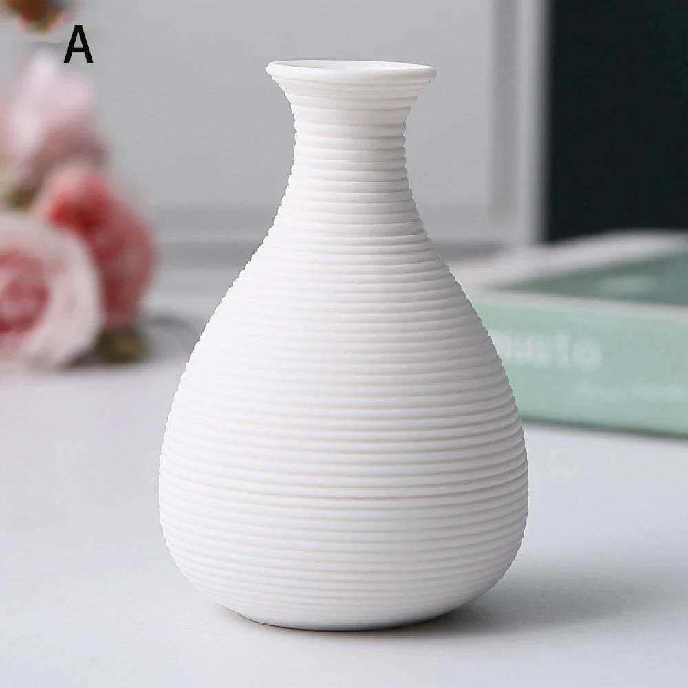 Black ceramic decorative vase D on bedside table with single dried branch accent