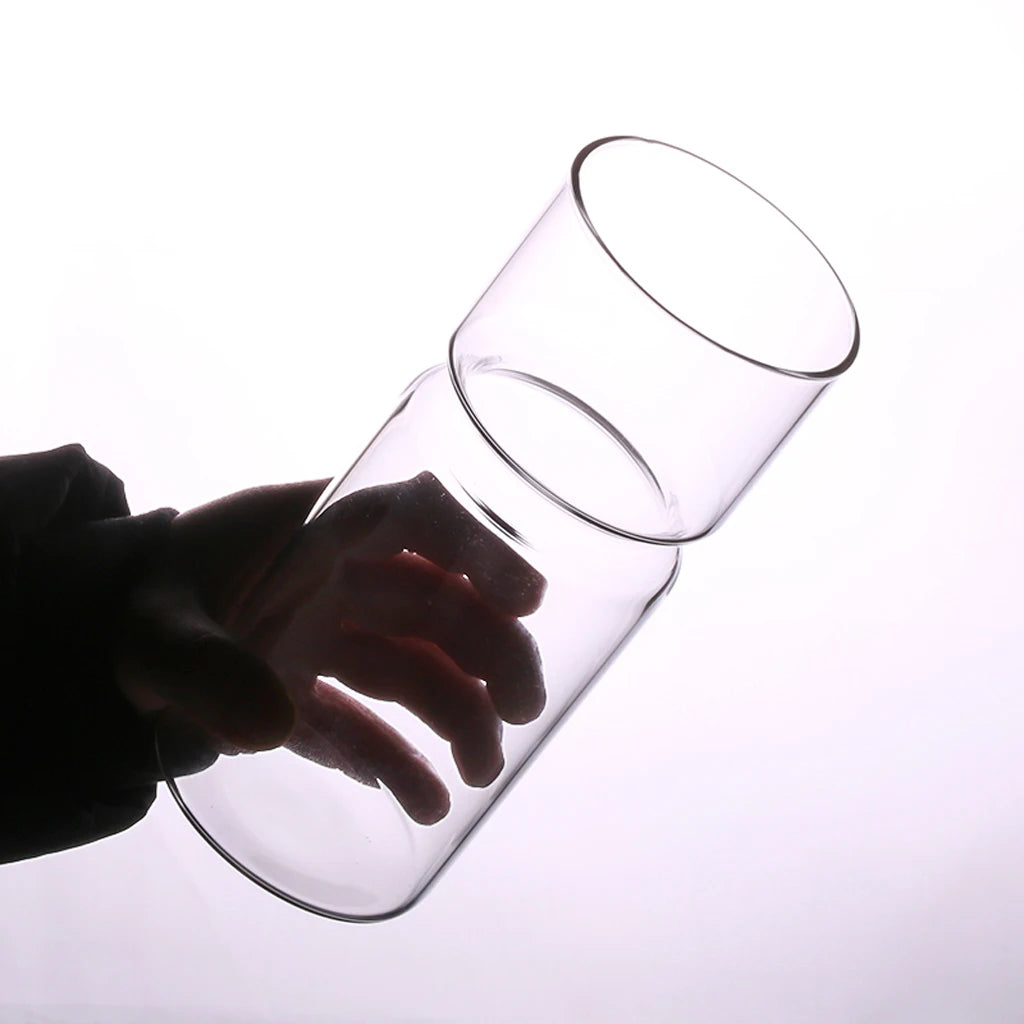 Set of clear glass hyacinth vases on a Zen styled wooden desk