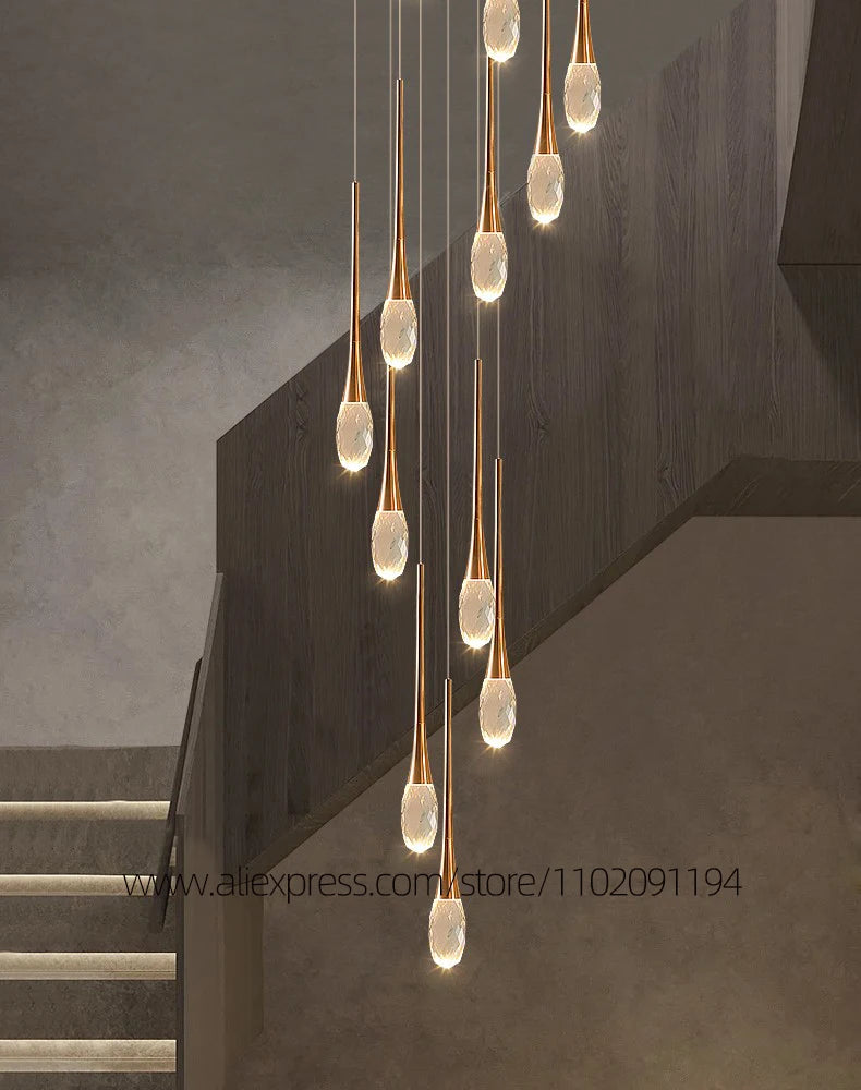 Polished crystal staircase chandelier with slim crystal rods on a gold frame