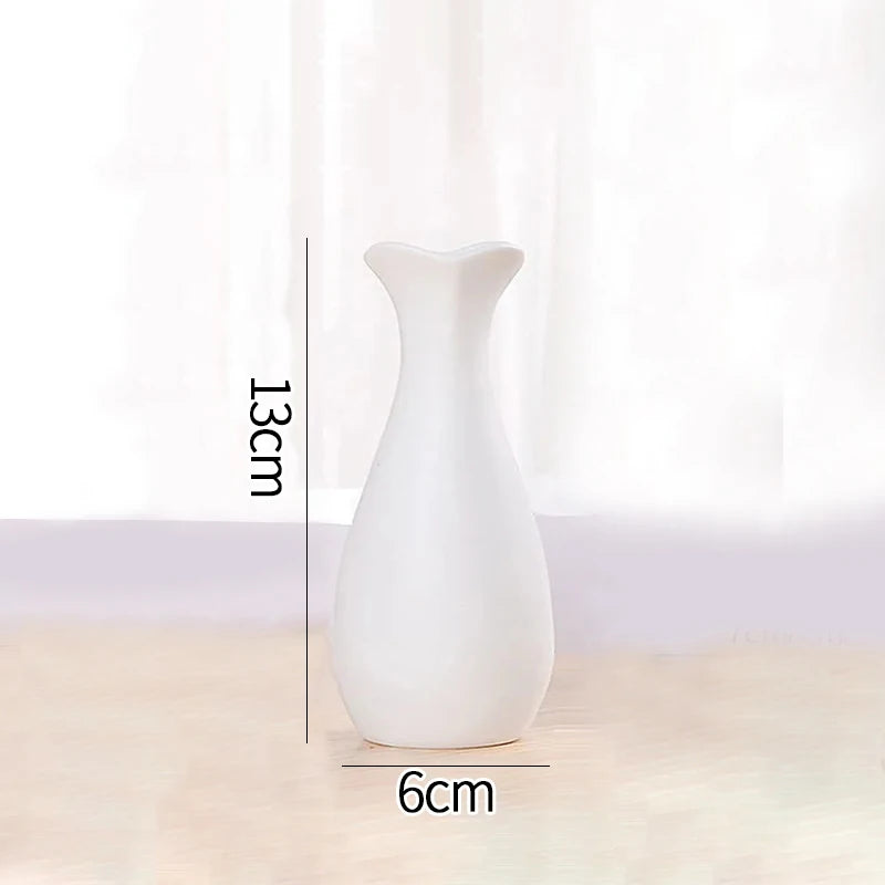 Overhead view of three Nordic white ceramic vases showing varying circular opening sizes