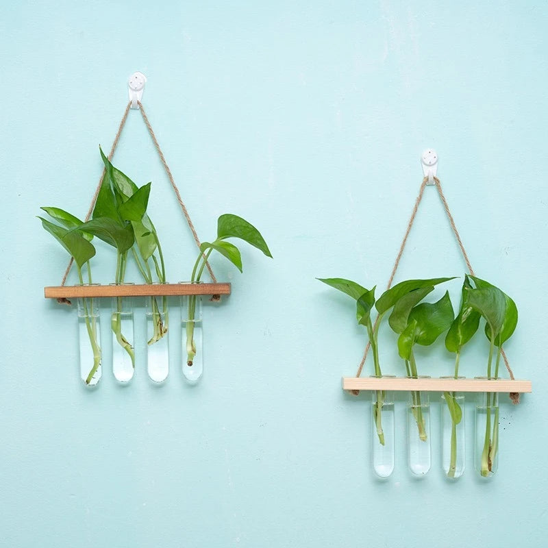 Wooden board and glass test tube wall vase styled in a botanical home office corner