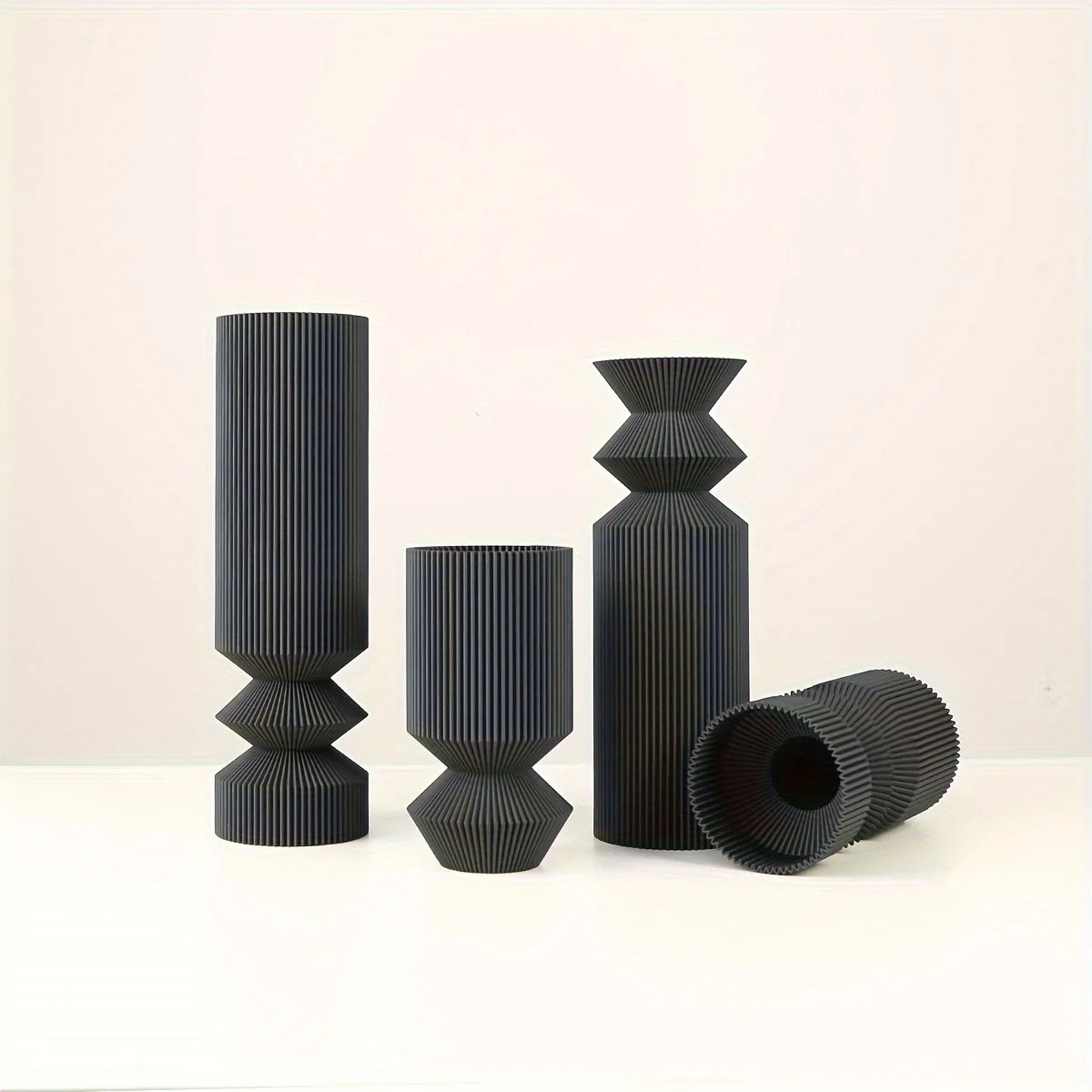Small matte black Nordic plastic vase with dried pampas on desk