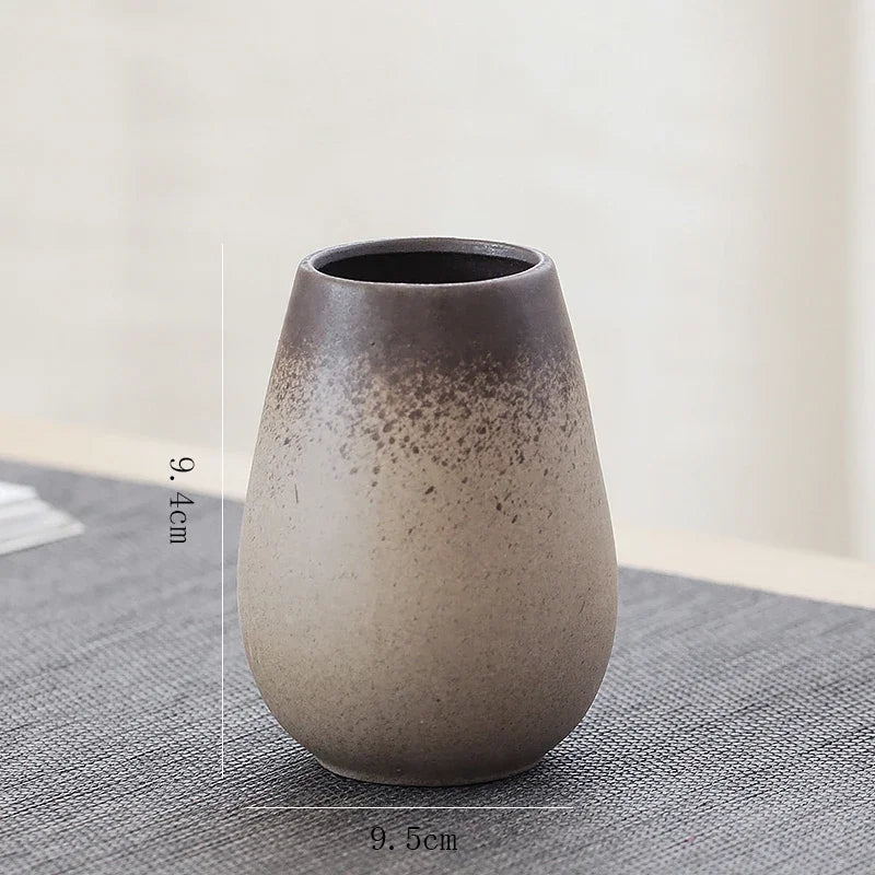 Classic Chinese pottery style I vase styled next to a calligraphy brush