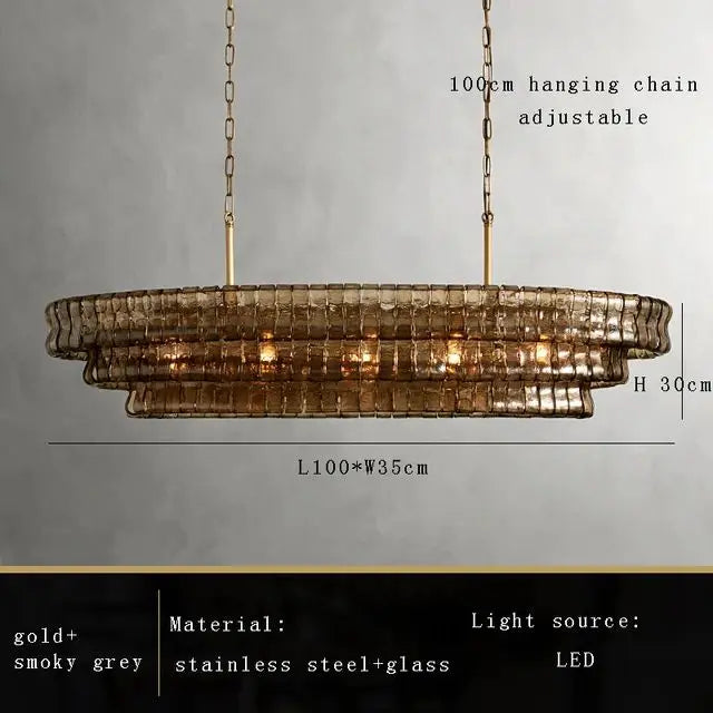 Clear glass shade detail on a gold finished chandelier arm