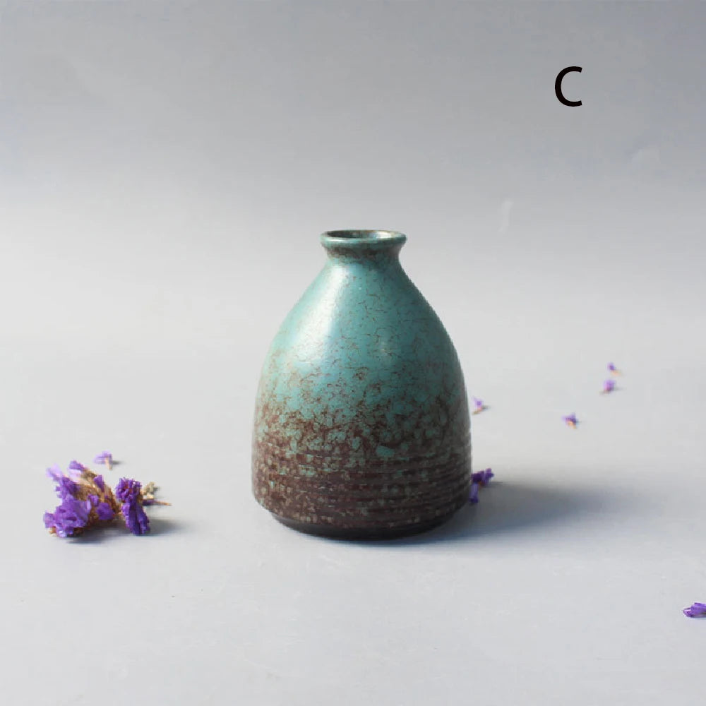 Set of five Japanese ceramic small vases arranged on shelf together