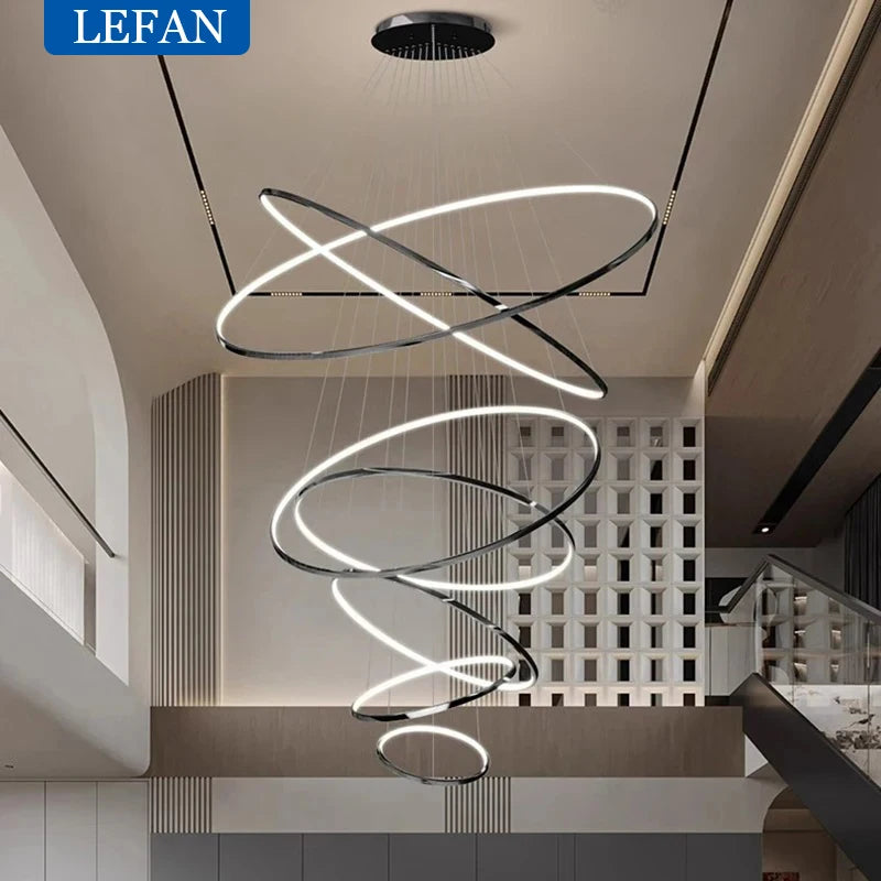 Three ring staircase chandelier in a gold forged aluminum finish