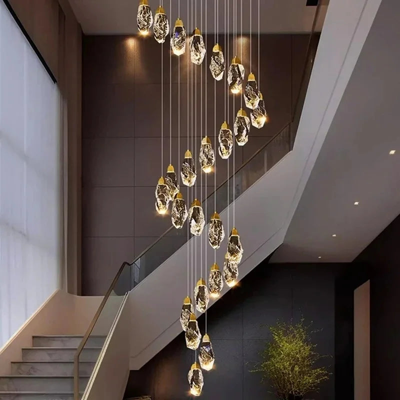 Gold chassis crystal chandelier spiralling down an open stairwell