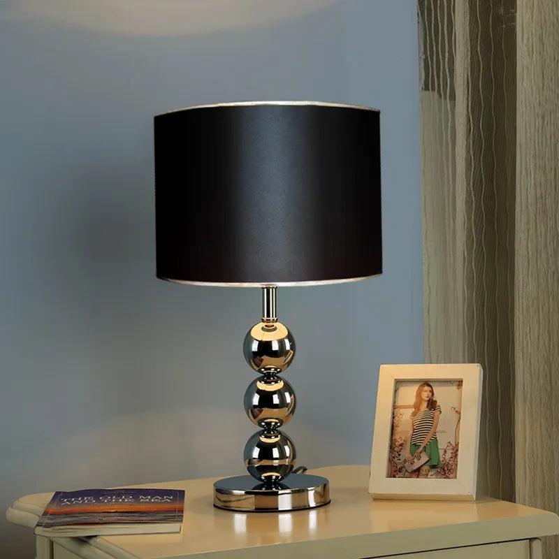 Nordic silver desk lamp angled view of base and slender stem