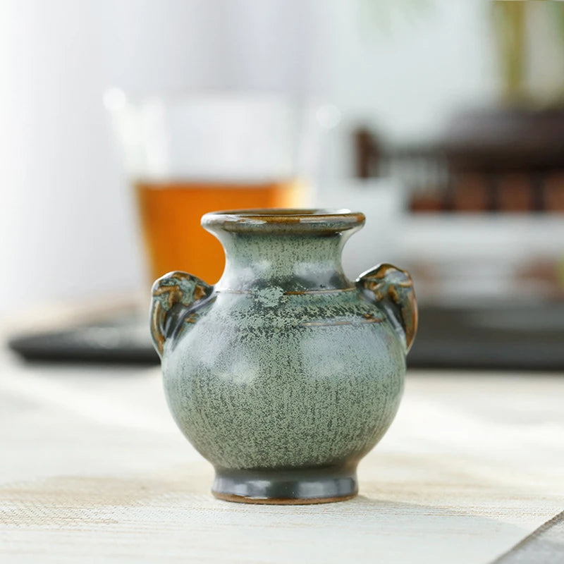 Green retro mini vase with plant stems hydroponic use