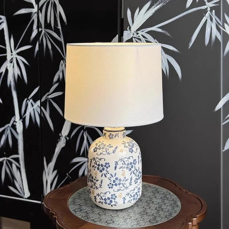 Close-up of hand-painted blue floral pattern on porcelain vase lamp