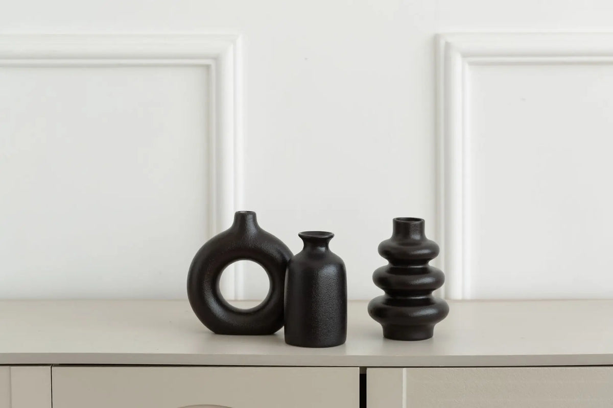 Black ceramic bohemian vase set displayed as living room console accent