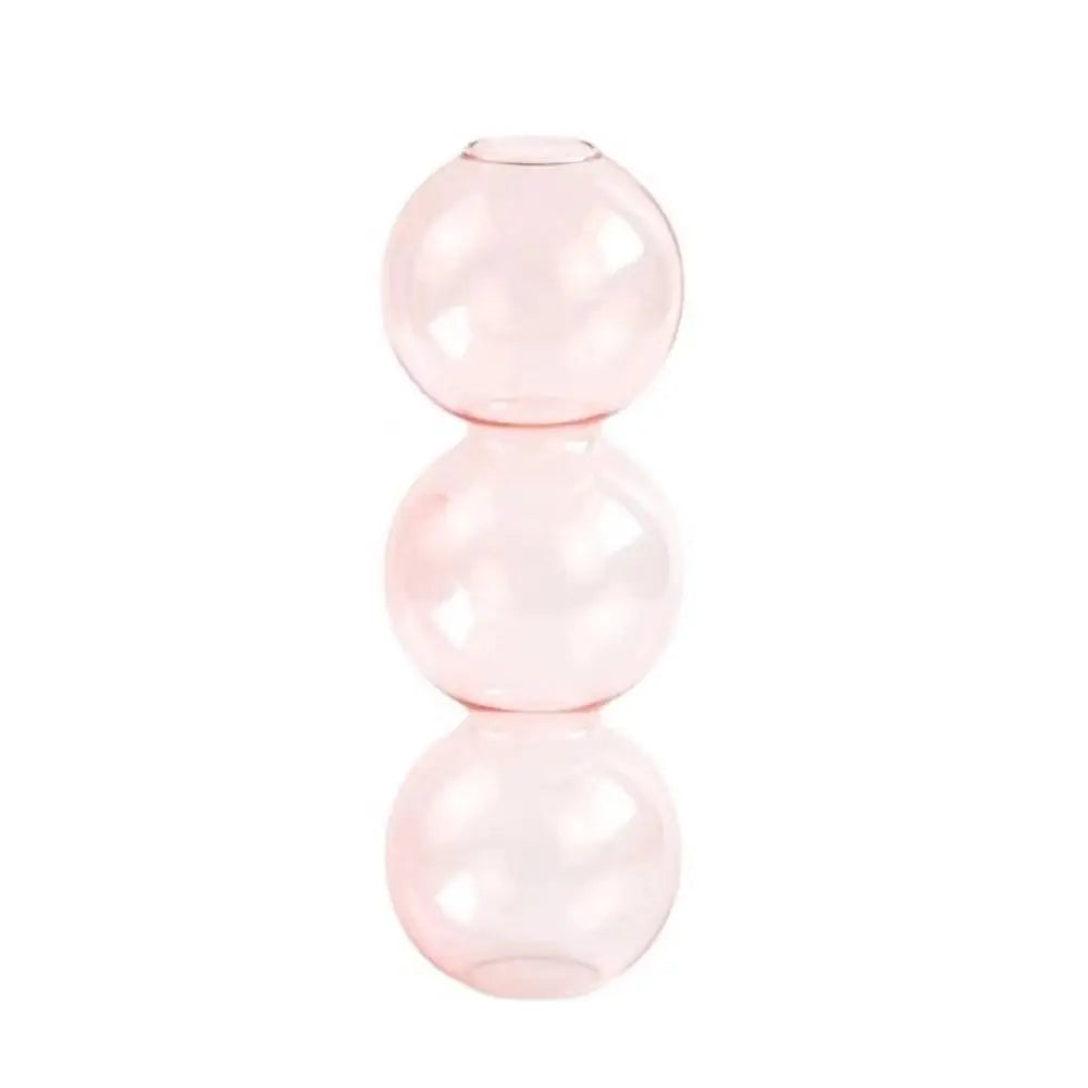 Three glass vases in color gradient arrangement from transparent to pink to blue
