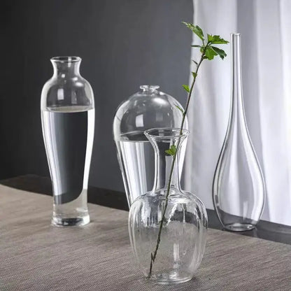 Zen glass cylinder bud vase style A with single branch on minimalist desk
