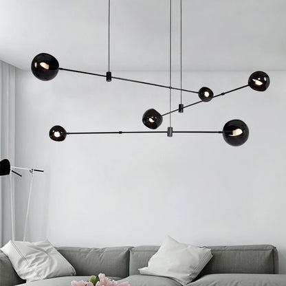 Black globe linear chandelier with stained glass shades on an iron bar